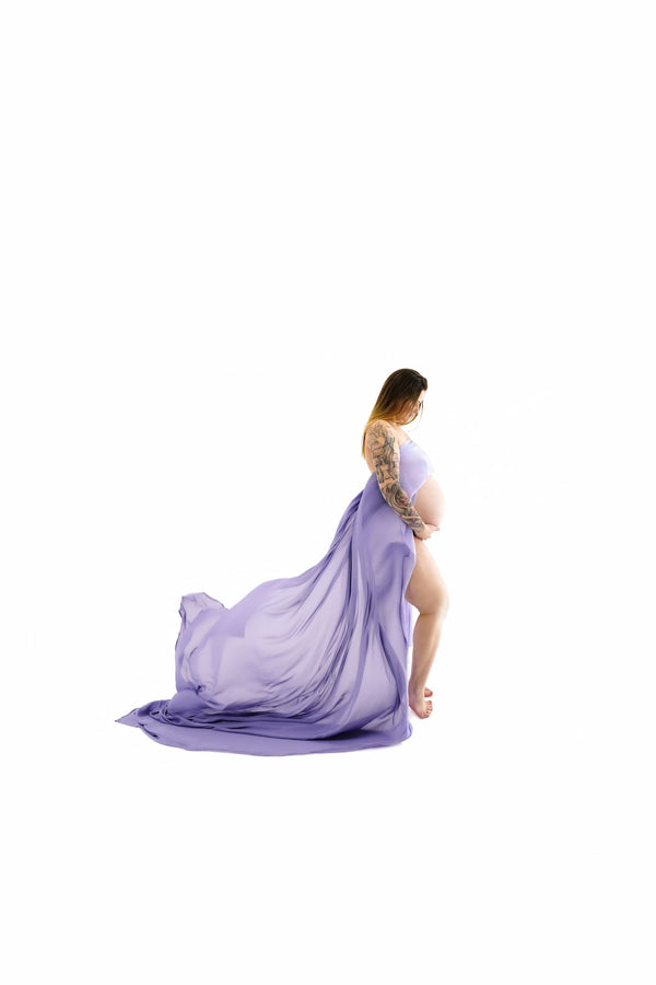 Pregnant individual posing for Nuovo’s Life collection on a white backdrop