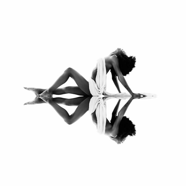 Black and white high-key photography from Self-Love Collection depicting tranquil confidence, draped in elegance, with a mirror reflection